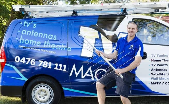 Brent from TV Magic standing in front of work van with tv antenna